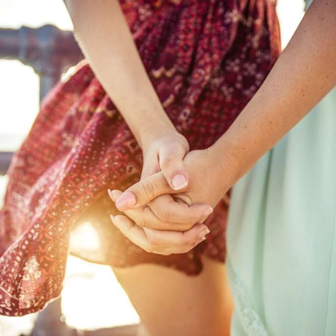 Two,Girls,Holding,Each,Other,Hands